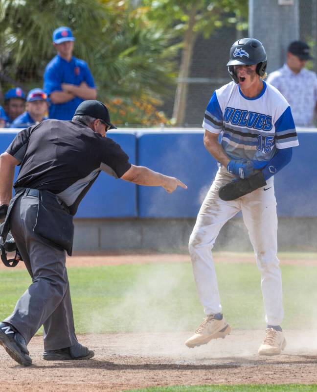 The umpire calls Basic runner Colin Hushaw (15) safe at home plate over Bishop Manogue during t ...