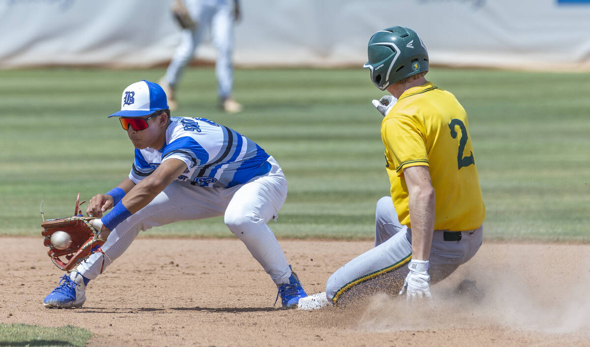 Basic short stop Ty Southisene (3) grabs a throw late as Bishop Manogue runner Joey Scolari (2) ...