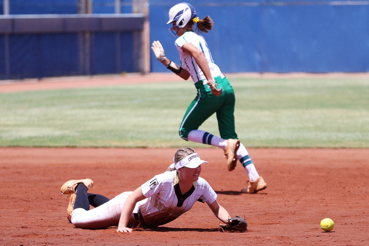 Faith Lutheran's Savannah Moore (15) knocks down a ground ball before picking it up for a Green ...
