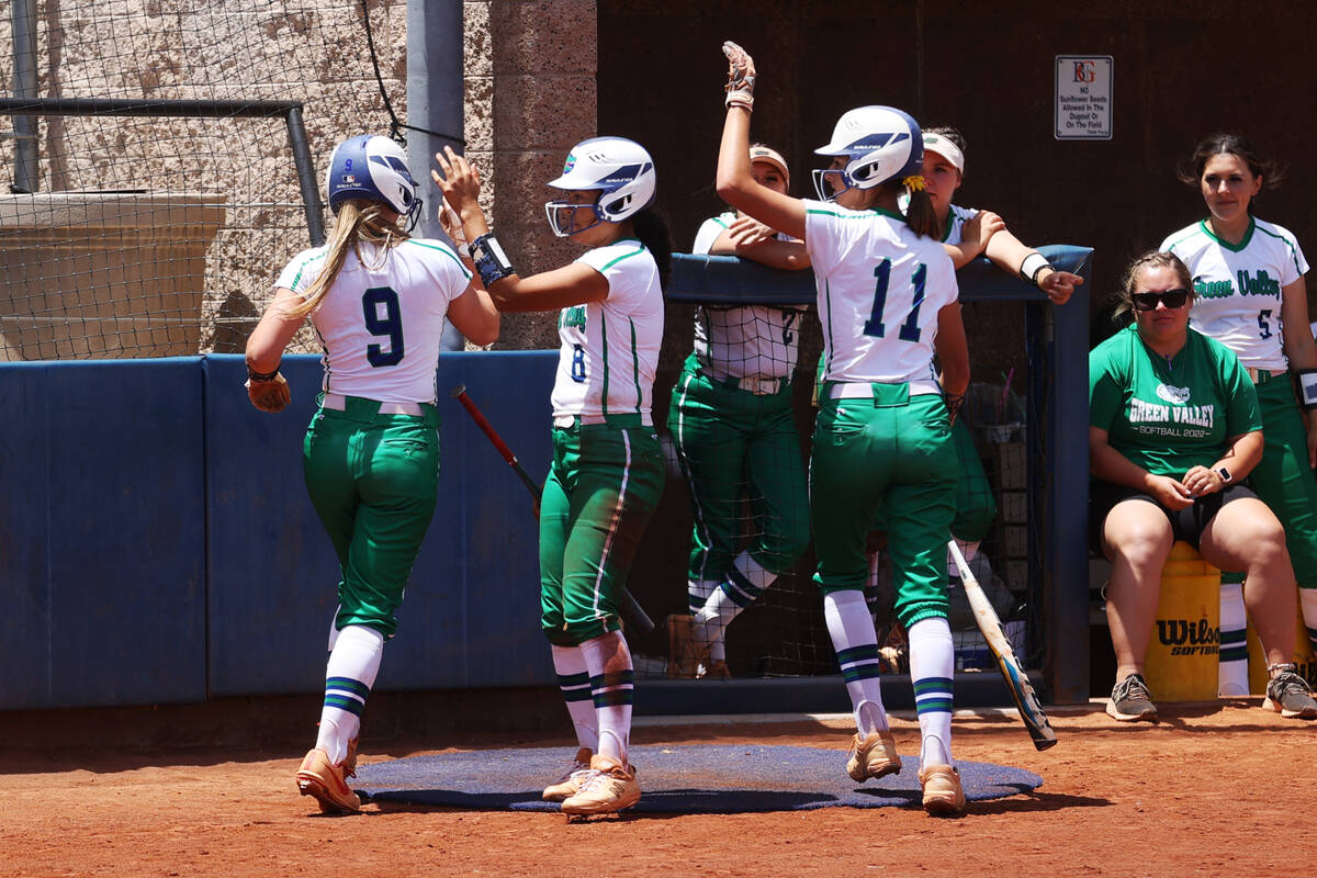 Green Valley's Michaela Morris (11) celebrates her run against Faith Lutheran with Liliana Espa ...