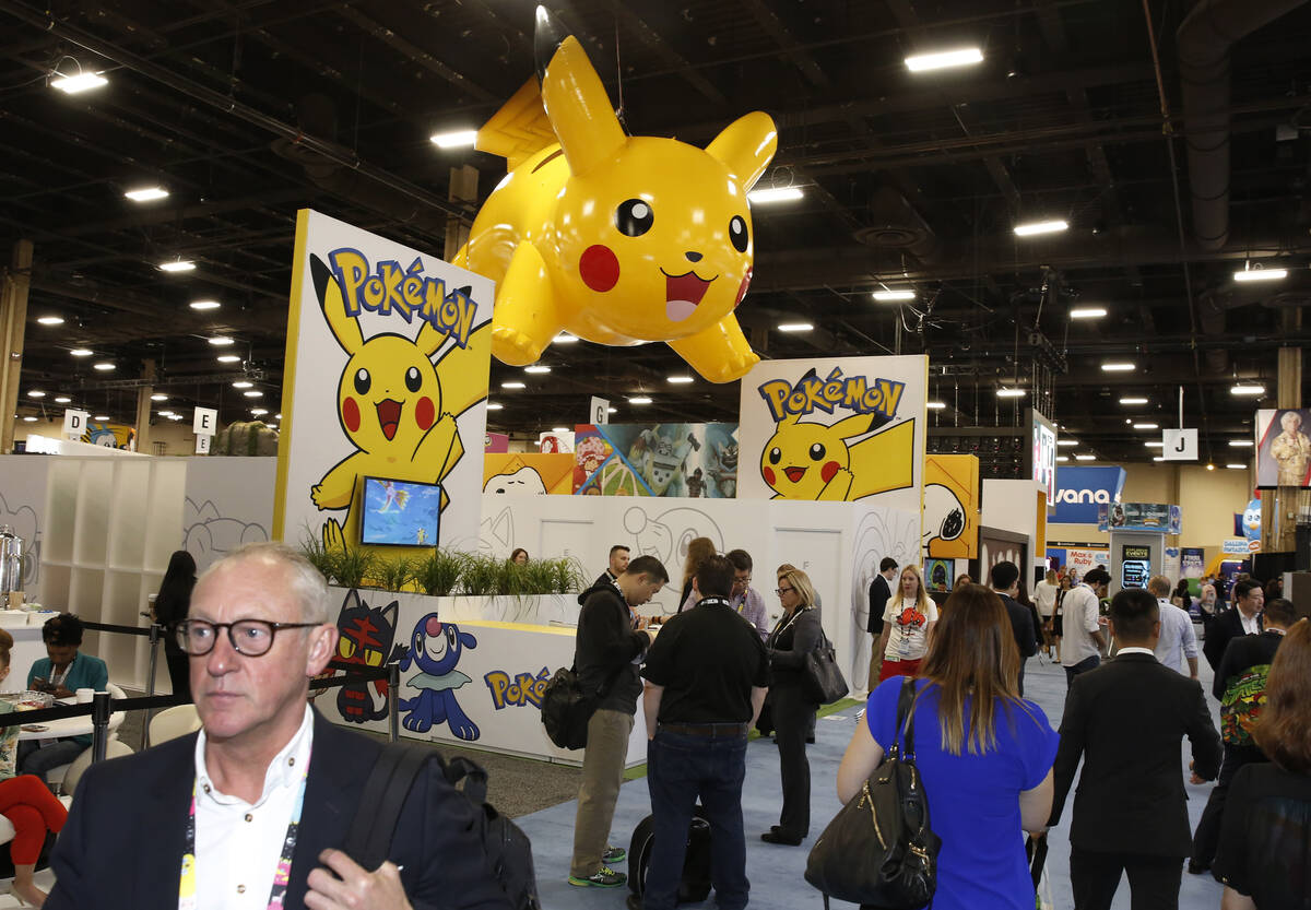 Expogoers walk past a "Pokemon" display at the 2018 Licensing Expo on Tuesday, May 22, 2018, in ...