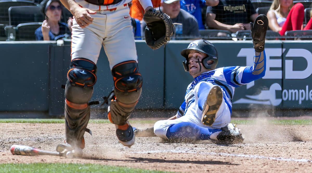 Basic runner Mason Neville (26) slides safely home as Bishop Gorman catcher Billy Scaldeferri ( ...