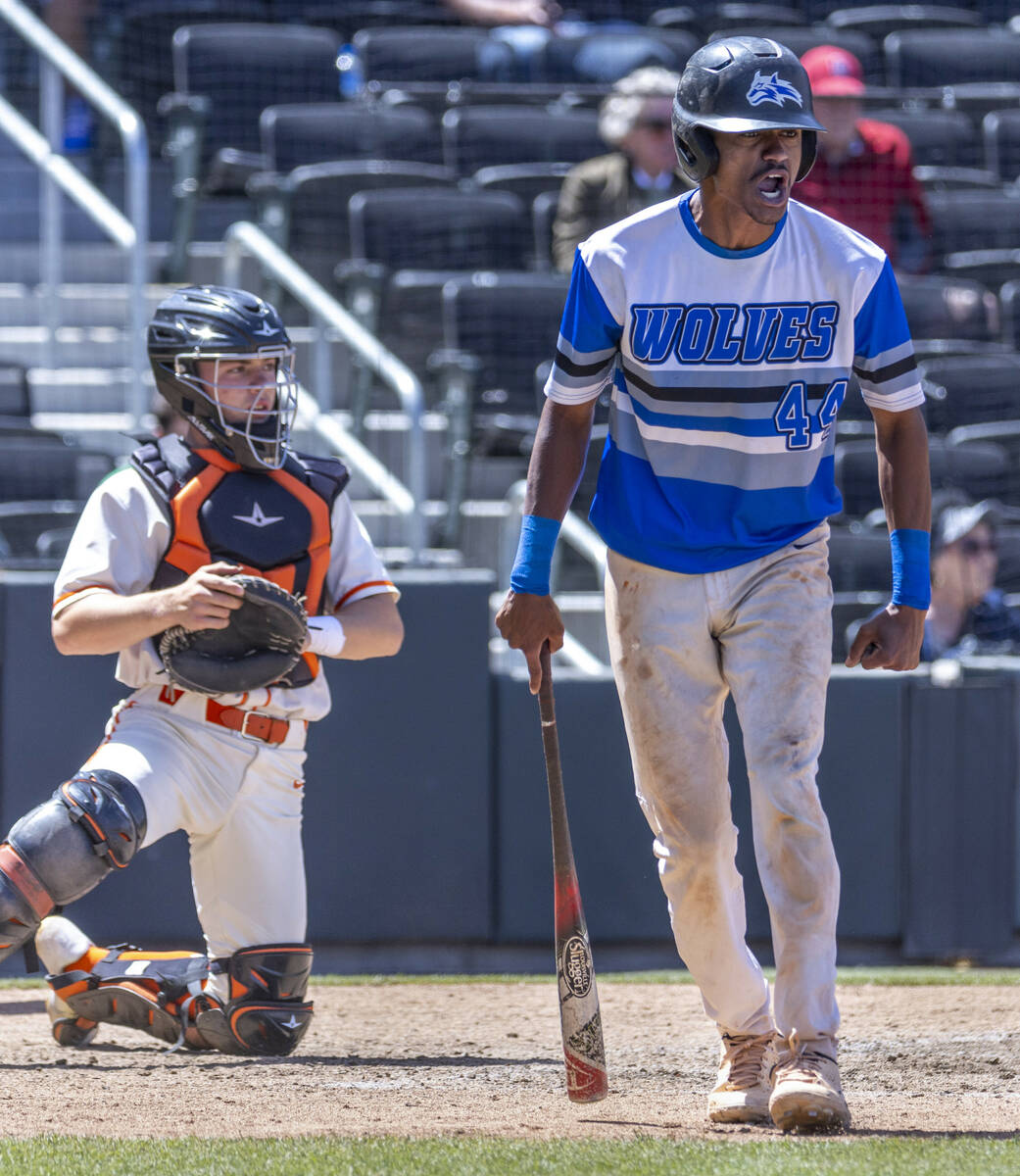 Basic runner Carl McCullough (44) yells to a teammate to keep running after scoring in front of ...