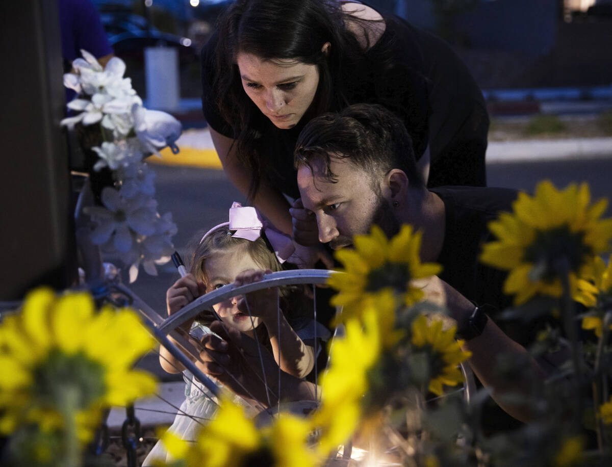 Attendees sign a bike during a memorial for Ben Black, 31, the bicyclist killed last Sunday in ...