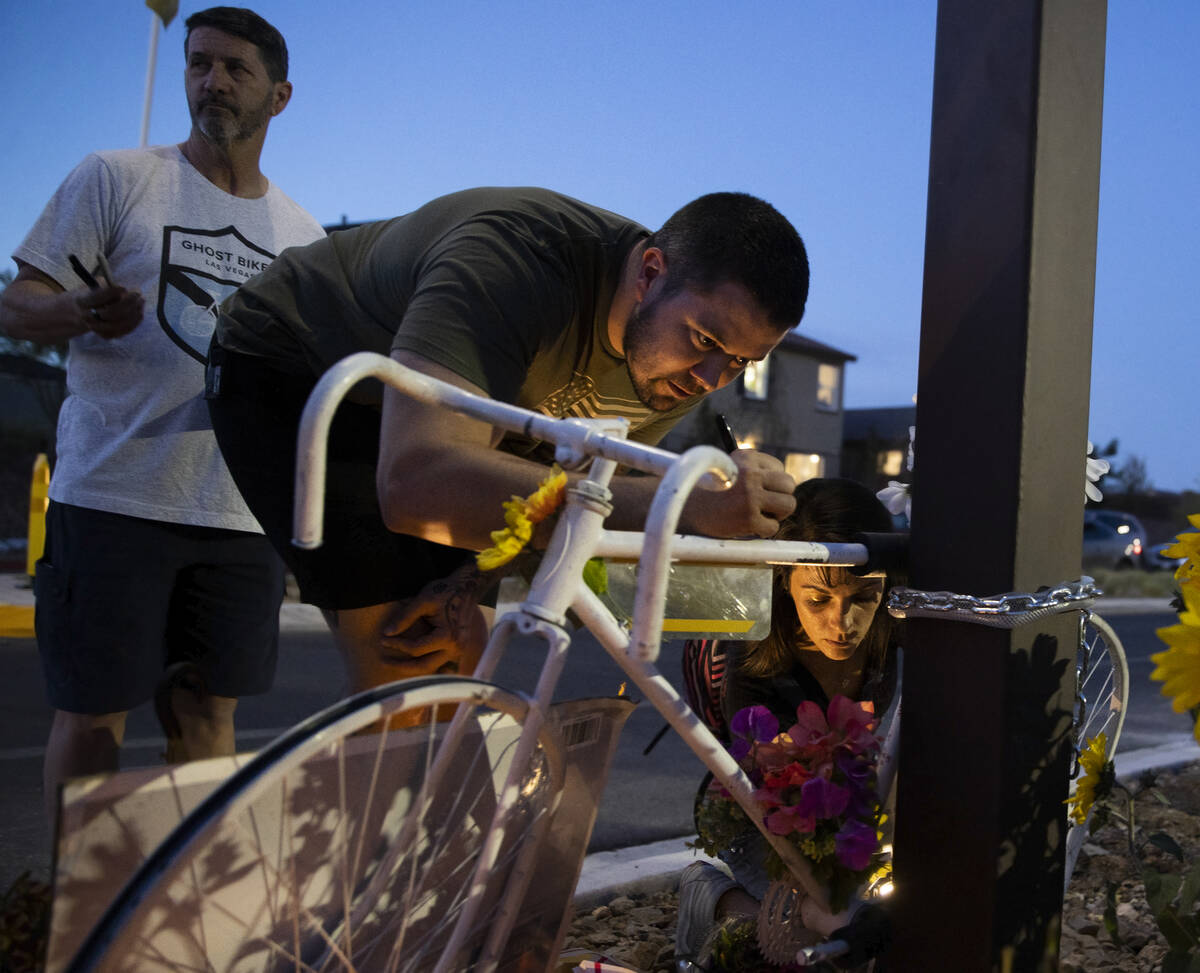 Attendees sign a bike during a memorial for Ben Black, 31, the bicyclist killed last Sunday in ...