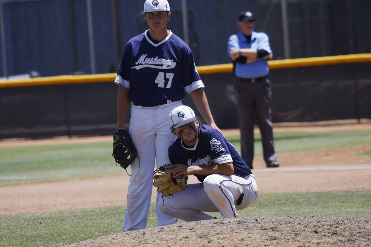 Shadow Ridge pitcher Jordan Bryan and his teammate Ian Grafmank (47) react after Legacy scored ...