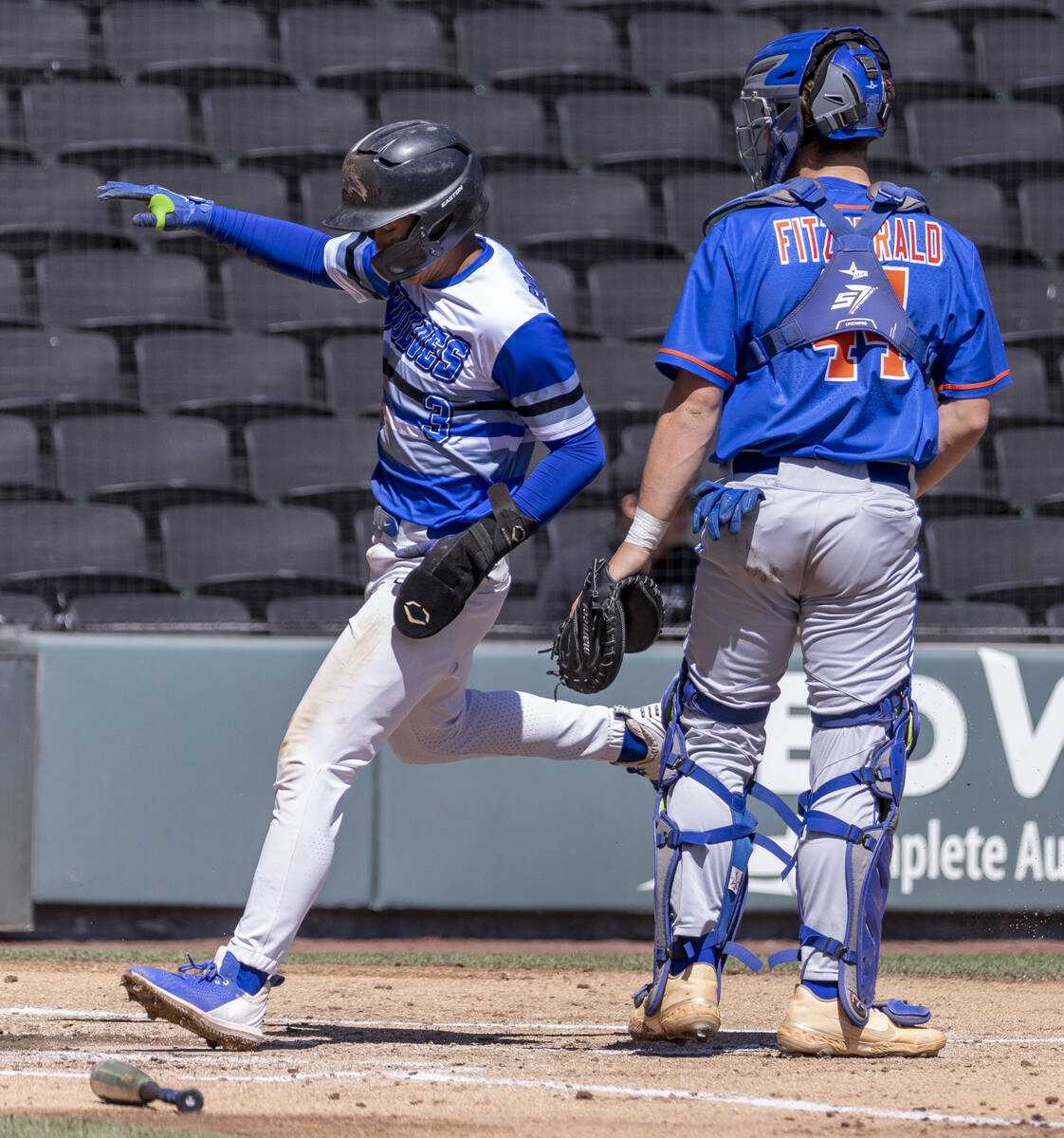 Basic runner Ty Southisene (3) scores past Bishop Gorman catcher Ben Fitzgerald (44) during the ...