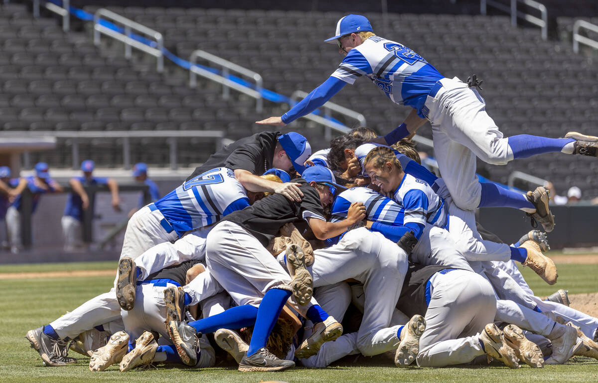 Basic players "dog pile" on the pitcher's mound in celebration of defeating Bishop Go ...