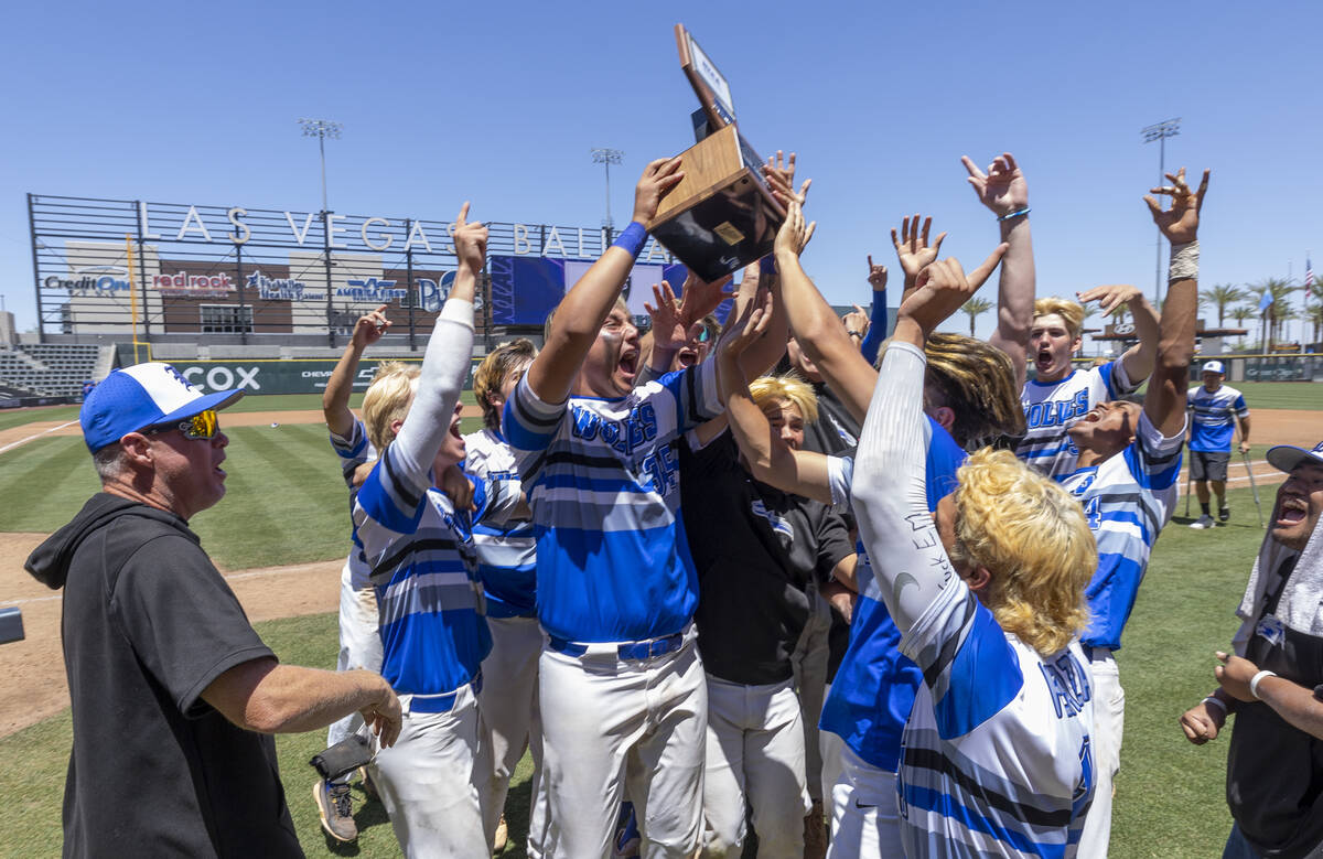 Basic players and coaches celebrate with the trophy after defeating Bishop Gorman 16-7 during t ...