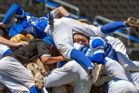 Basic players "dog pile" on the pitcher's mound in celebration of defeating Bishop Go ...