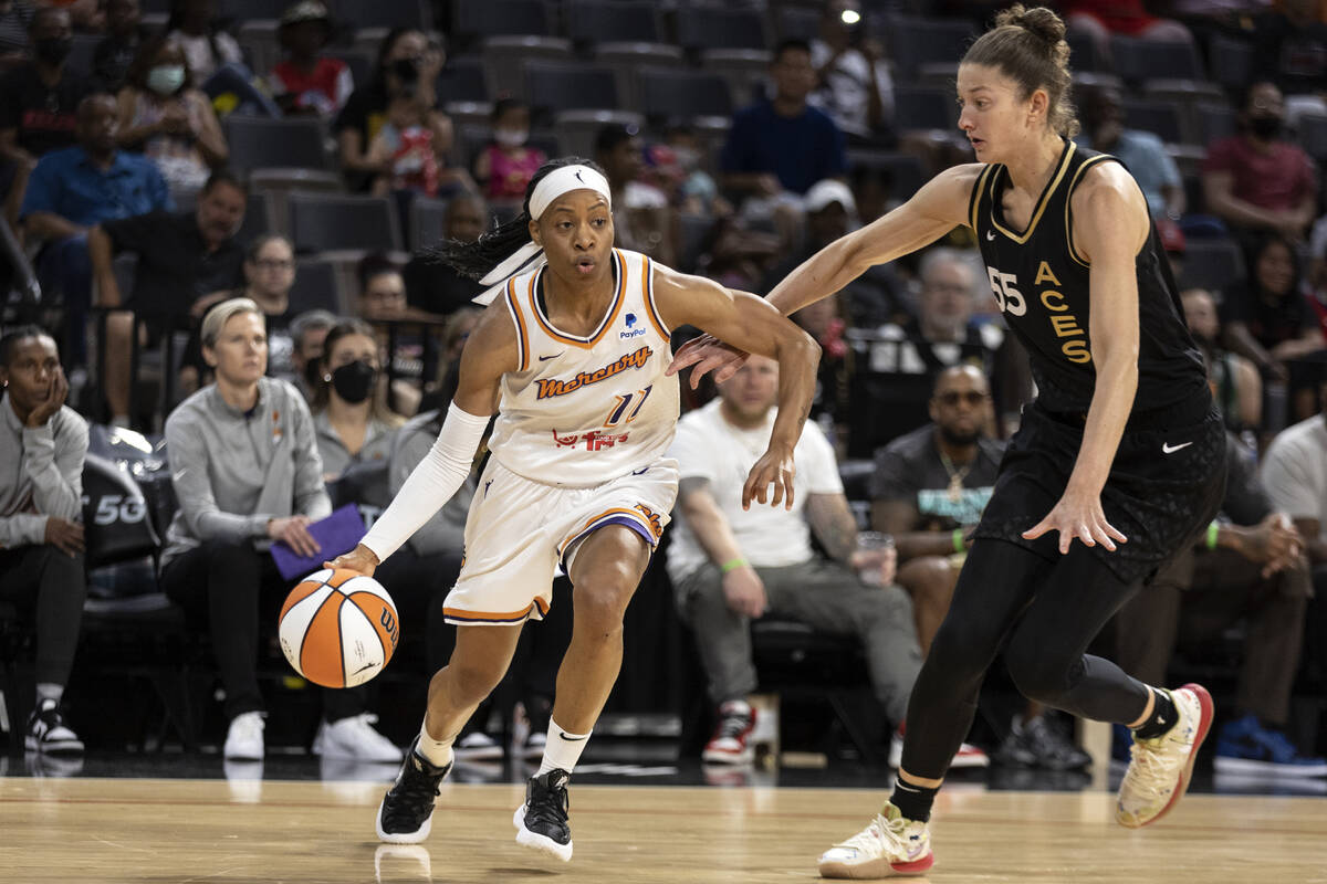 Phoenix Mercury guard Shey Peddy (11) dribbles around Las Vegas Aces forward Theresa Plaisance ...