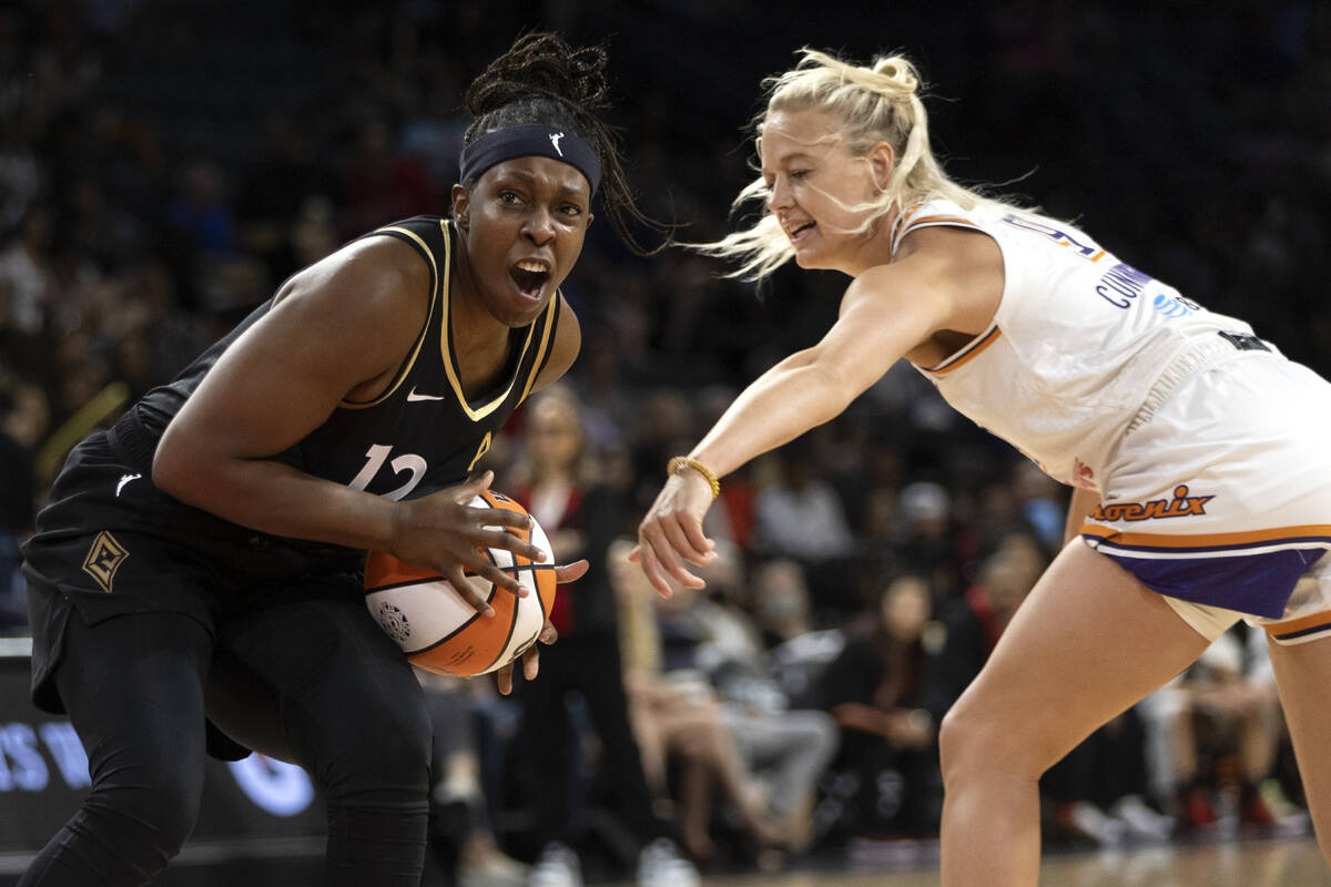 Las Vegas Aces guard Chelsea Gray (12) drives around Phoenix Mercury guard Sophie Cunningham (9 ...