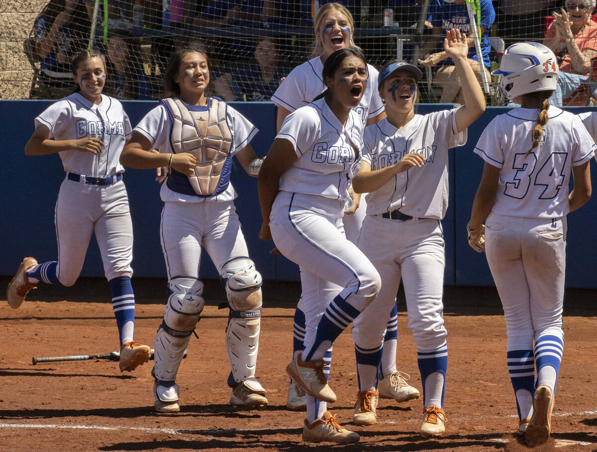 Bishop Gorman players greet Gianna Hornyak (34) as she steps on home plate during a Class 4A st ...