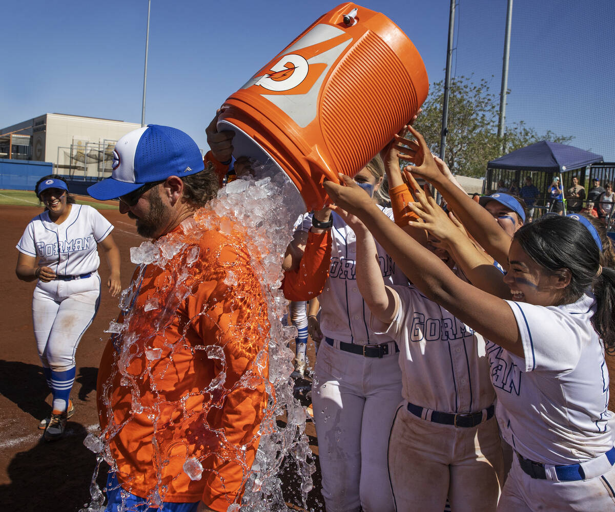 Bishop Gorman players celebrate by giving head coach Kevin Smith, left, a Gatorade bath after b ...