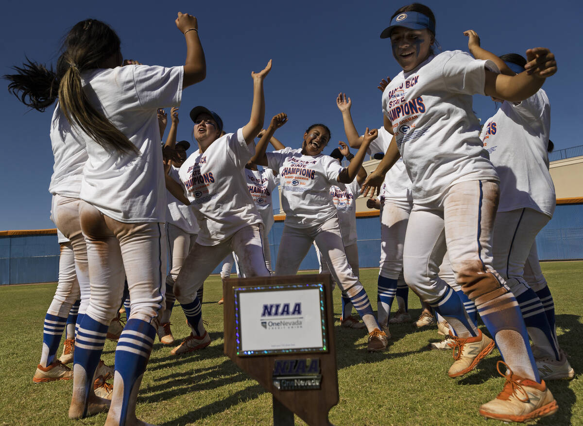 Bishop Gorman players dance in front of the state championship trophy after beating Silverado t ...