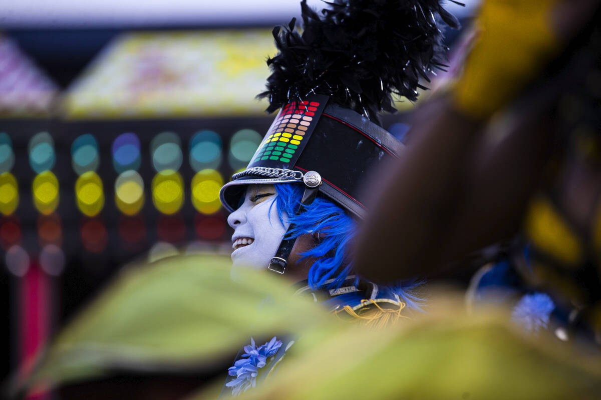 Entertainers walk the festival grounds during day three of Electric Daisy Carnival on Sunday, M ...