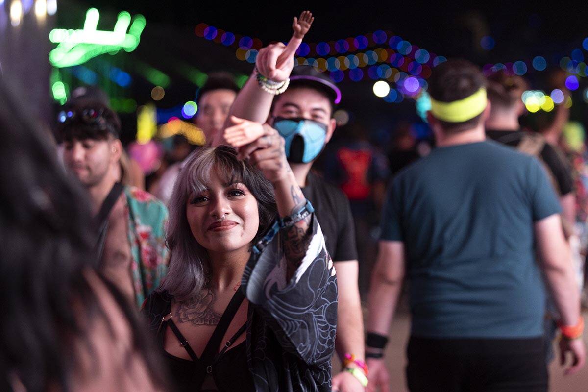 Attendees wear tiny hands while dancing through Memory Lane during the second day of the Electr ...