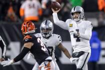 Raiders quarterback Derek Carr (4) makes a throw over Cincinnati Bengals free safety Jessie Bat ...