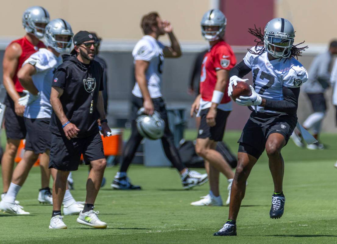 Raiders wide receiver Davante Adams (17) pulls in a pass as offensive coordinator Mick Lombardi ...
