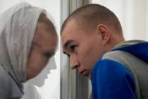 Russian Sgt. Vadim Shishimarin listens to his translator during a court hearing in Kyiv, Ukrain ...