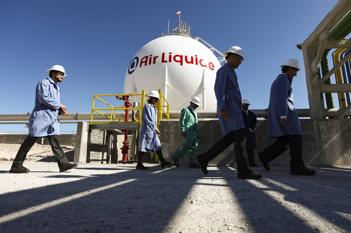 People walk by the liquid hydrogen storage sphere during a tour of the Air Liquide liquid hydro ...