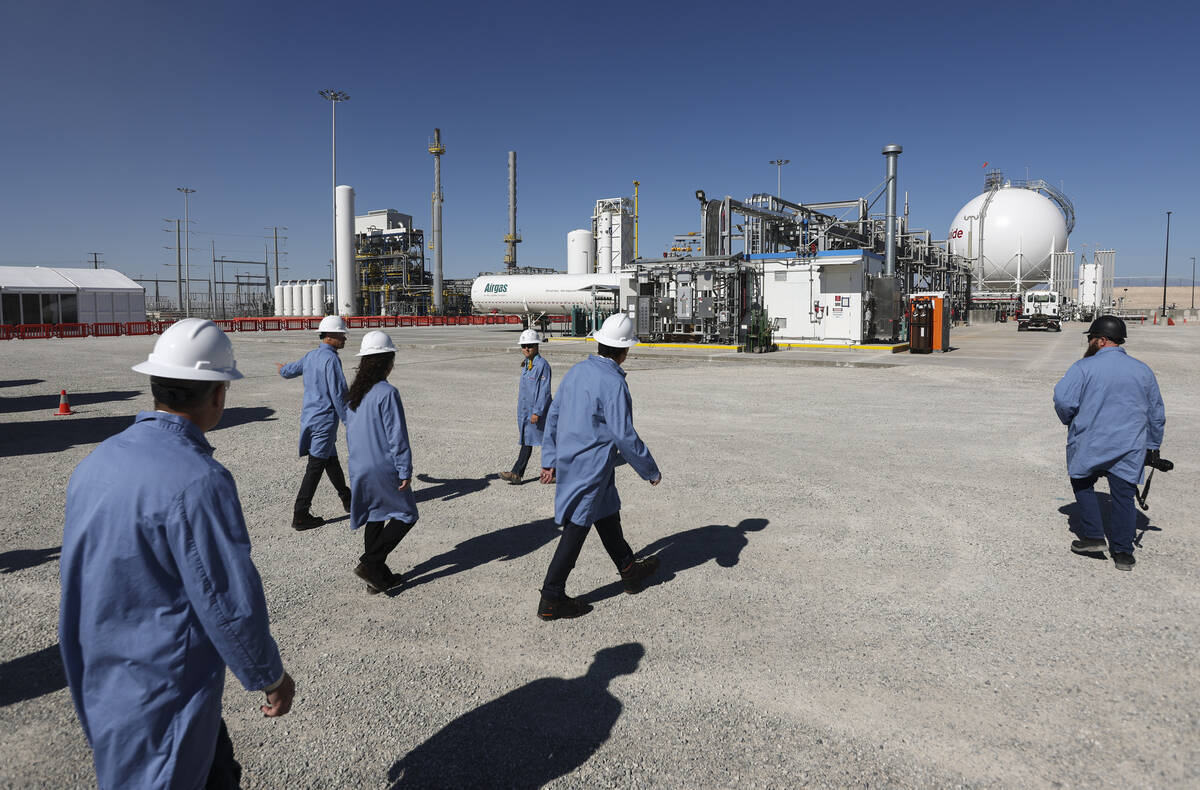 People walk during a tour of the Air Liquide liquid hydrogen facility on Tuesday, May 24, 2022, ...