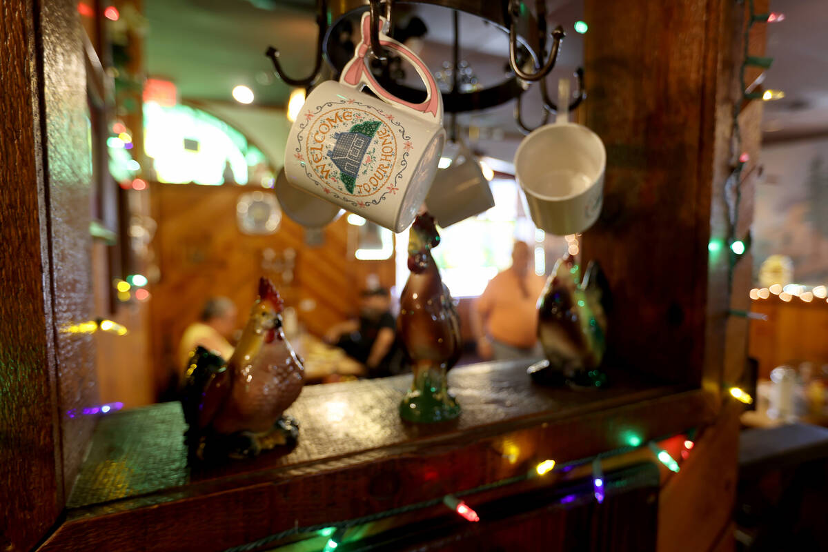 Coffee mugs hang at The Omelette House in Las Vegas Monday, May 23, 2022. A thief walked out th ...