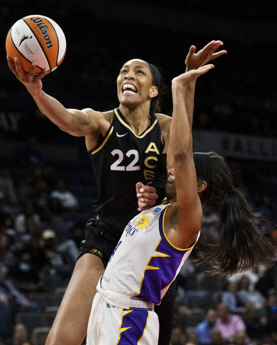 Aces forward A'ja Wilson (22) drives past Los Angeles Sparks guard Lexie Brown (4) in the first ...