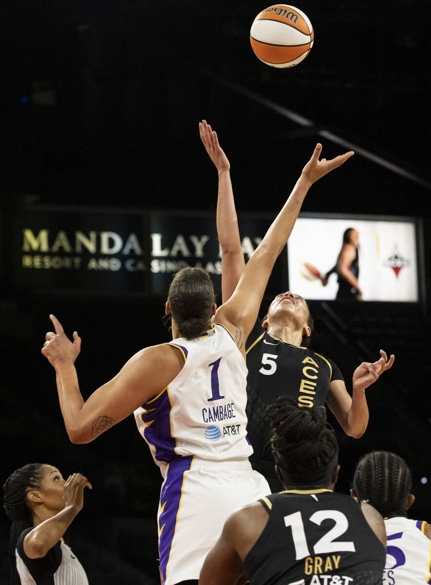 Aces forward Dearica Hamby (5) leaps for a jump ball with Los Angeles Sparks center Liz Cambage ...
