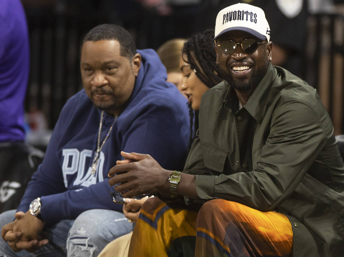 Miami Heat legend Dwyane Wade, right, takes in the action between the Aces and the Los Angeles ...