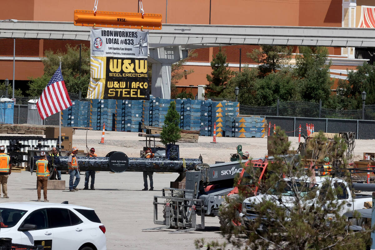 Workers prepare the final beam to be placed at the top of the MSG Sphere at The Venetian during ...
