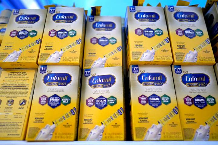 Infant formula is stacked on a table during a baby formula drive to help with the shortage May ...