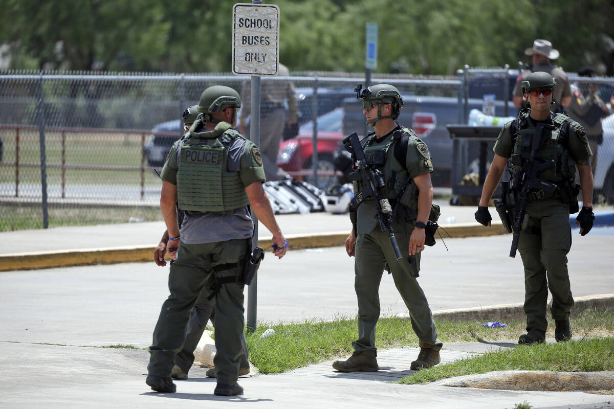Law enforcement personnel stand outside Robb Elementary School following a shooting, Tuesday, M ...