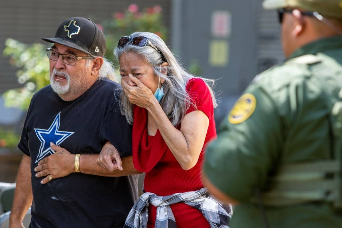 A woman cries as she leaves the Uvalde Civic Center, Tuesday May 24, 2022, in Uvalde, Texas (W ...