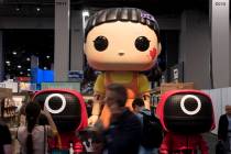 People walk past the Funko booth displaying larger than live versions of the companies popular ...