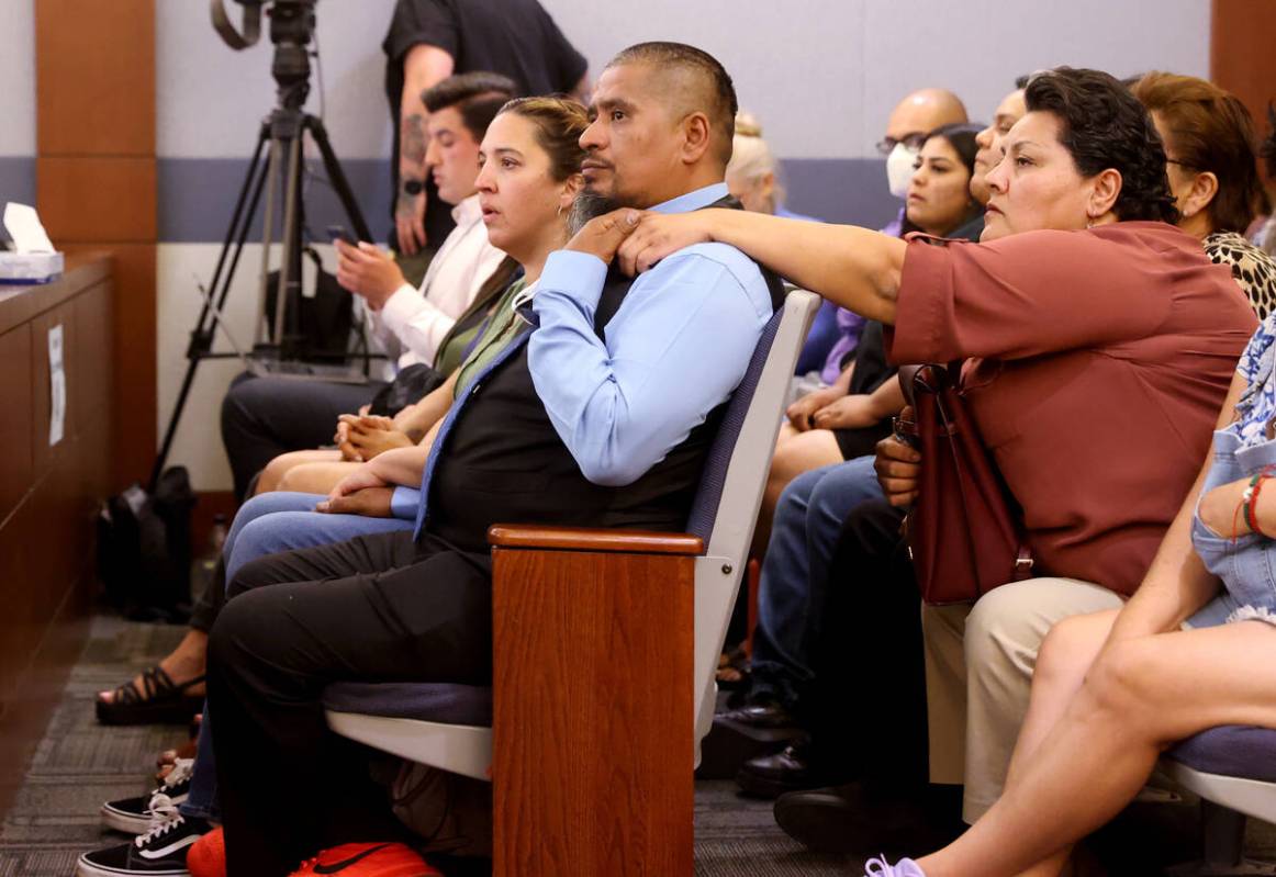 Ivan Arenas, father of Marcos Arenas, is comforted by his stepmother Anna Arenas as they wait f ...