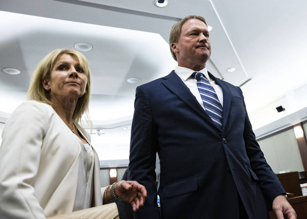 Former Raiders coach Jon Gruden, and his wife Cindy leave the courtroom after appearing at a he ...