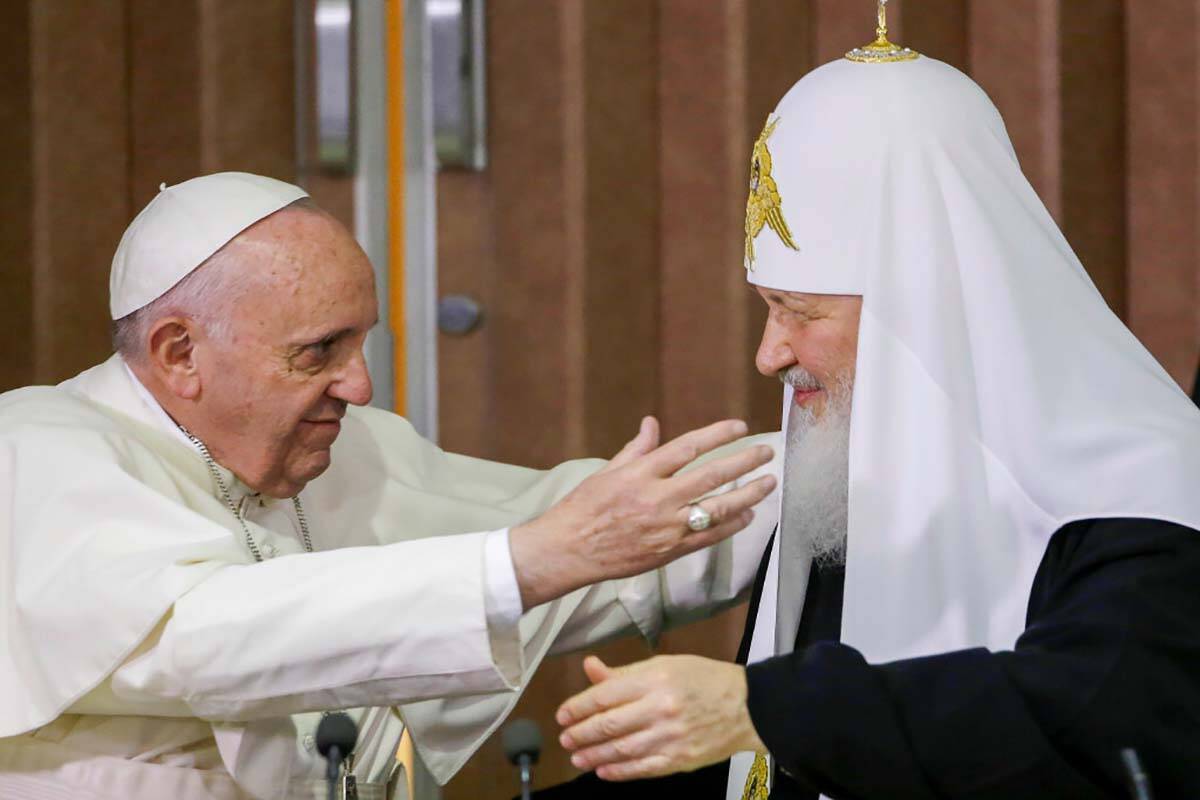 FILE — Pope Francis, left, reaches to embrace Russian Orthodox Patriarch Kirill after signing ...