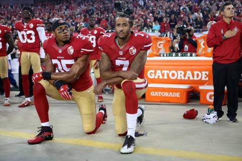 San Francisco 49ers Eric Reid (35) and Colin Kaepernick (7) take a knee during the national ant ...