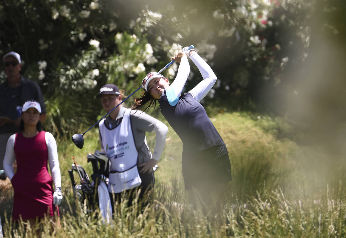 Kelly Tan tees off at the 12th hole while playing against Danielle Kang, left, in the first rou ...