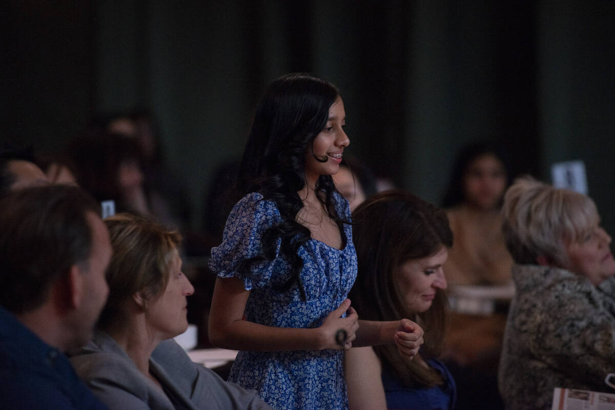 Liberty High School's Devika Bhatnagar, a tenth grader, gets up to accept her award at the Revi ...