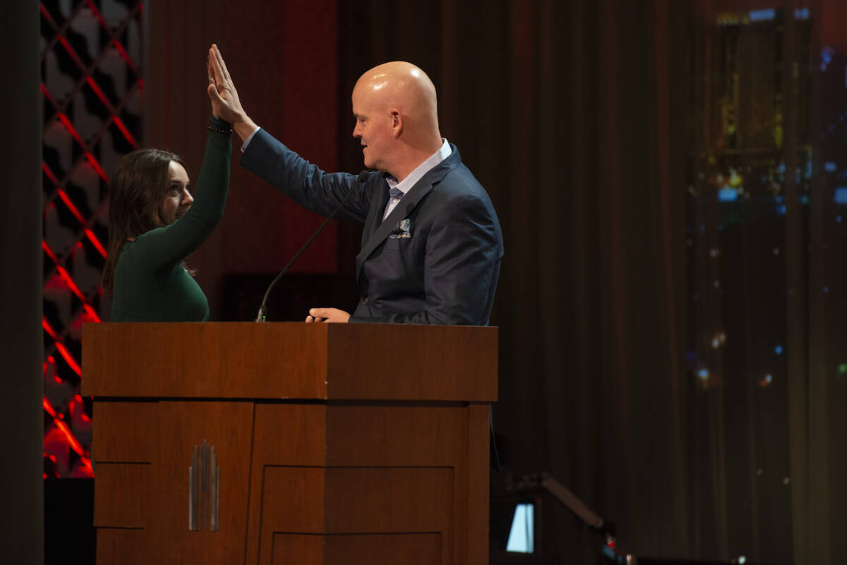 Las Vegas Academy of the Arts twelfth grader Sofia Kelemen, left, high fives emcee Chet Buchana ...