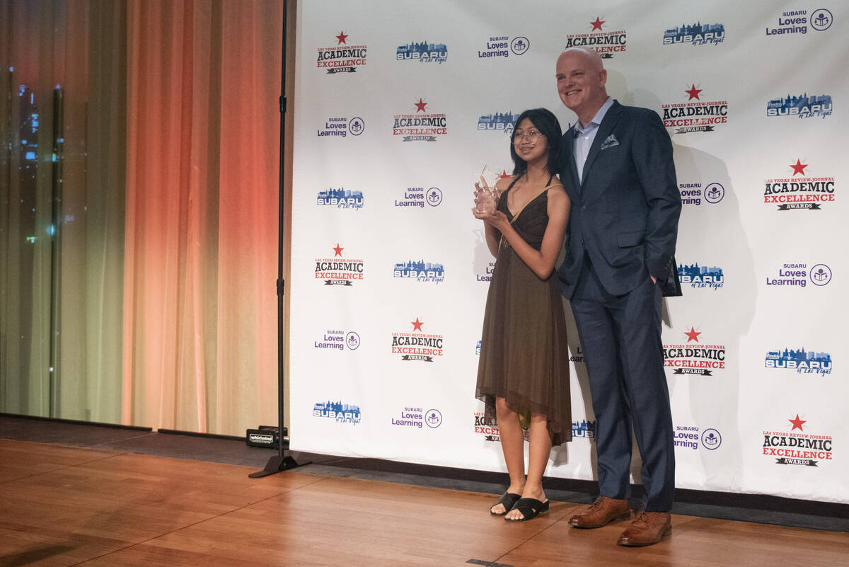 Green Valley High School's Mischa Abad, a ninth grader, poses for a photo with emcee Chet Bucha ...