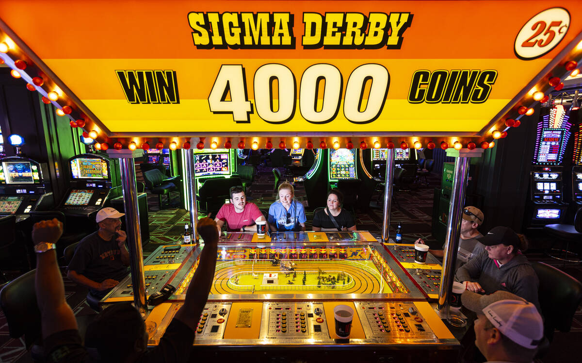 A participant celebrates while playing the coin-operated Sigma Derby game at the D Las Vegas on ...