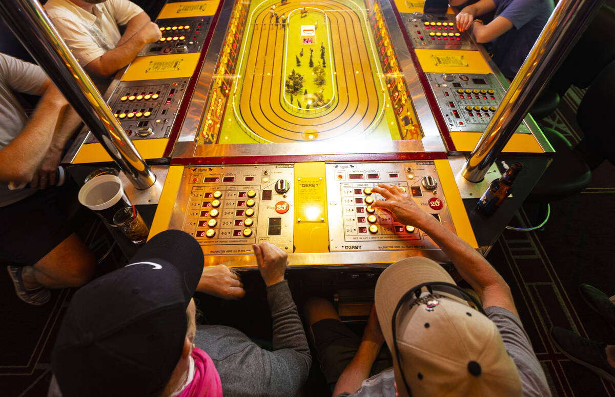 Andy Sheehan, right, of Henderson, and Deborah Smith, of Connecticut, play the coin-operated Si ...