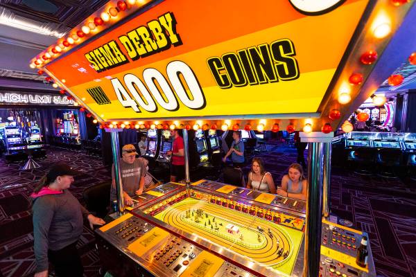 People play the coin-operated Sigma Derby game at the D Las Vegas on Tuesday, May 24, 2022, in ...