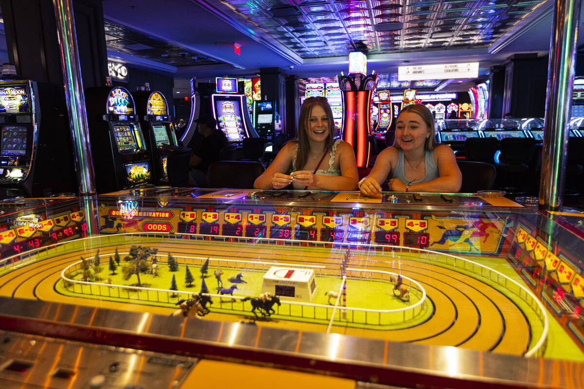 Emily Kissel, left, and Jordyn Keddy, both of Ariz., play the coin-operated Sigma Derby game at ...