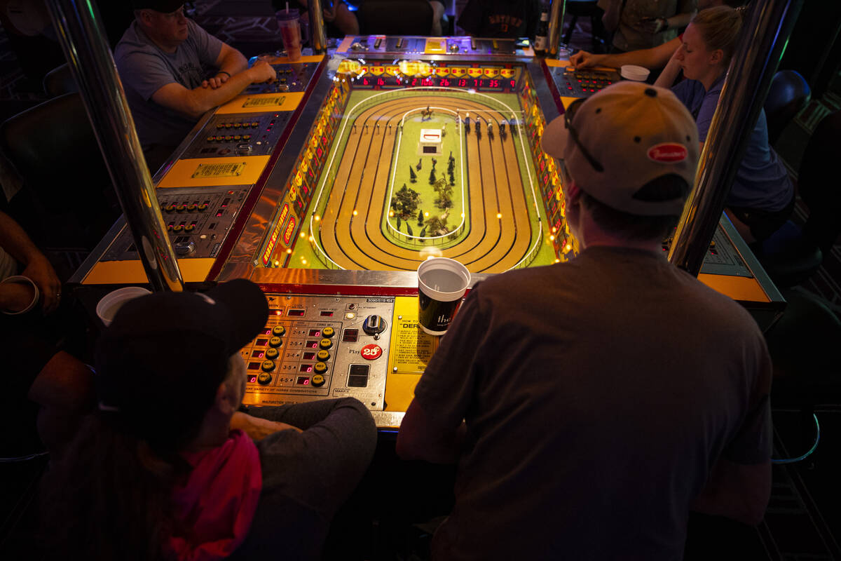 Andy Sheehan, right, of Henderson, and Deborah Smith, of Connecticut, play the coin-operated Si ...