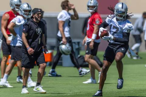 Raiders wide receiver Davante Adams (17) pulls in a pass during practice at the Raiders headqua ...