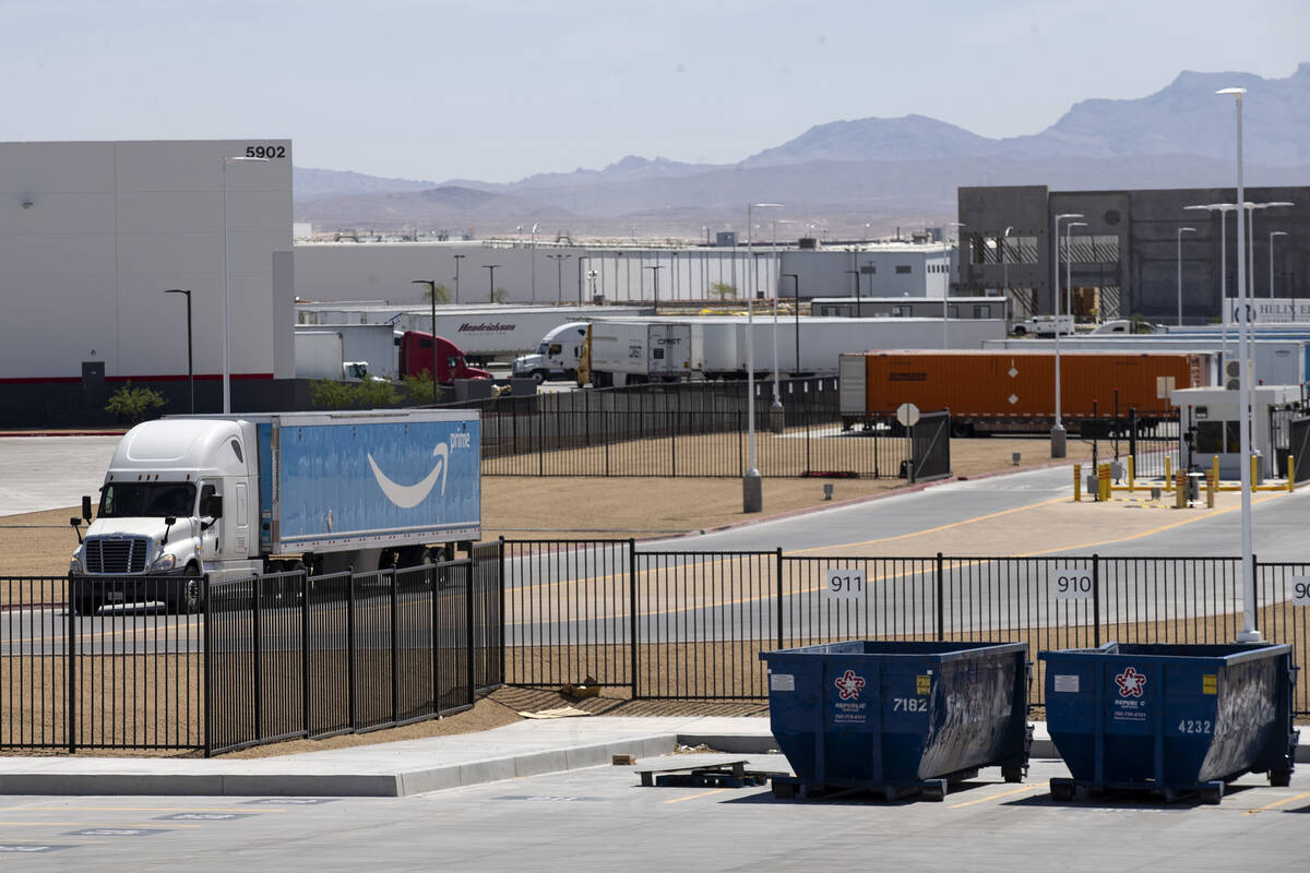 An Amazon Prime truck drives past one of two industrial buildings recently sold by developer Ca ...